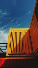 Low angle view of yellow building against sky