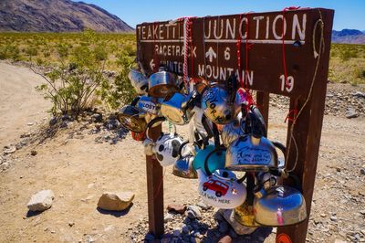 Various tea kettles hanging on signboard at death valley national park
