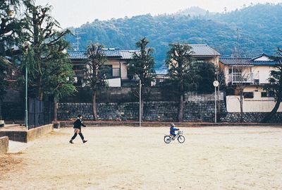 Man standing by tree