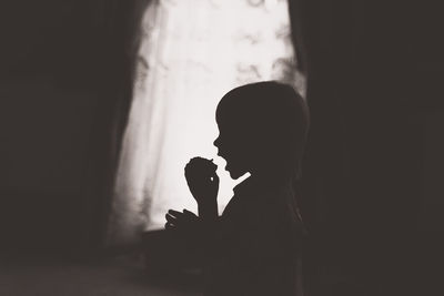 Silhouette of child at home