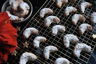 Handmade vanilla crescents on gold cooling grid