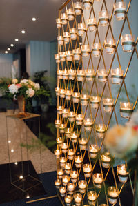 Candles burning in glasses on metal stand