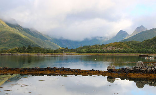 Scenic view of lake and mountains against sky