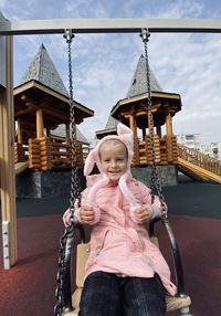 Portrait of cute girl against built structure