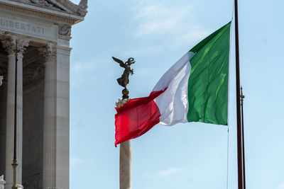 Italian flag in front of fatherland from piazza venezia also known as monument to victor emmanuel