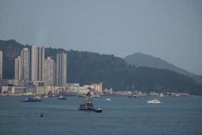 Sailboats in sea against clear sky