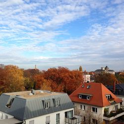 Residential buildings against cloudy sky