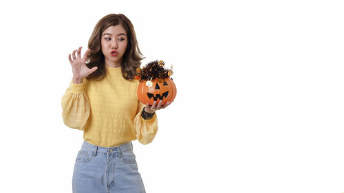 Full length of woman wearing mask against white background