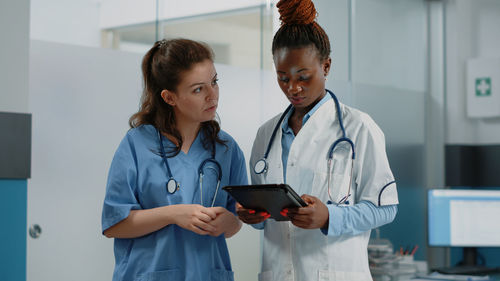 Female doctor using mobile phone