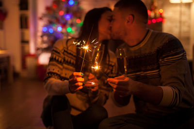 Couple holding lit candles