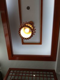 Low angle view of illuminated pendant light in building