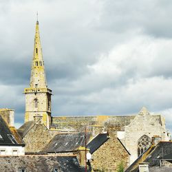 Bell tower against sky in city