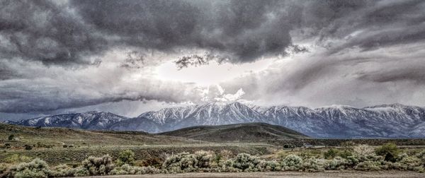 Scenic view of mountains against cloudy sky