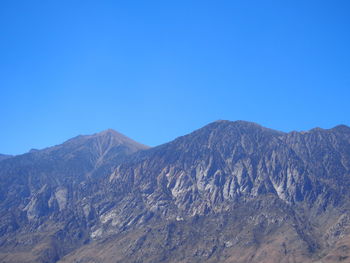 View of mountain range against blue sky