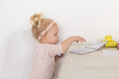 High angle view of girl drawing on table