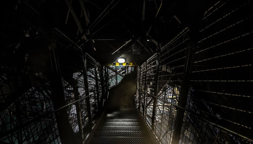 Low angle view of illuminated street lights at night