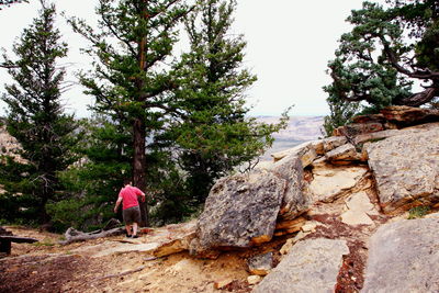 Full length of woman standing on rock