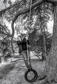 Portrait of woman on tree trunk