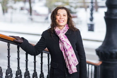 Portrait of young businesswoman standing in city