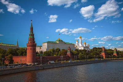 River amidst buildings against sky in city