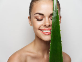 Portrait of a beautiful young woman over white background