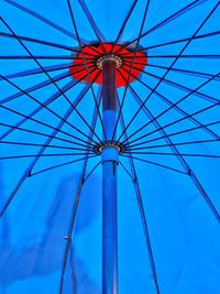 Low angle view of ferris wheel against blue sky