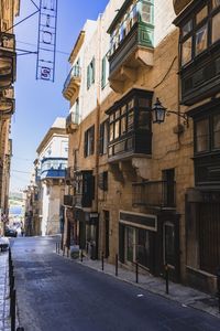 Empty road amidst buildings in town