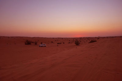 Scenic view of desert against sky during sunset