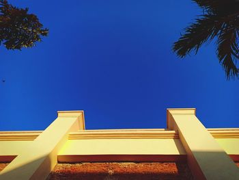 Low angle view of building against clear blue sky