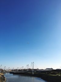 Bridge over river against blue sky