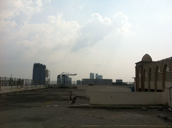 Buildings against cloudy sky