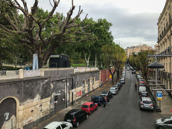 Traffic on road amidst buildings in city