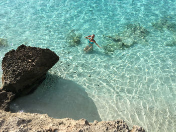 High angle view of woman swimming in sea