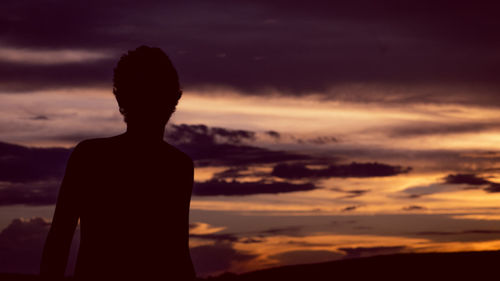 Silhouette man standing against sky during sunset