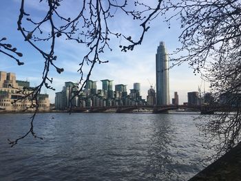 River and buildings against sky