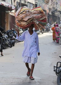 Rear view of woman working on street