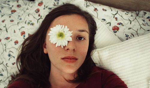 Portrait of woman lying on bed