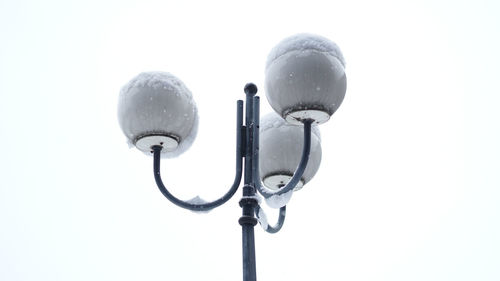 Low angle view of street light against white background