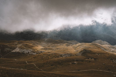 Scenic view of landscape against sky during foggy weather