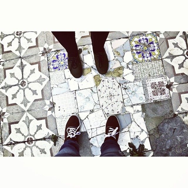 low section, shoe, person, transfer print, standing, lifestyles, men, footwear, auto post production filter, leisure activity, human foot, high angle view, cobblestone, personal perspective, tiled floor