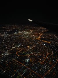 Aerial view of illuminated cityscape against sky at night