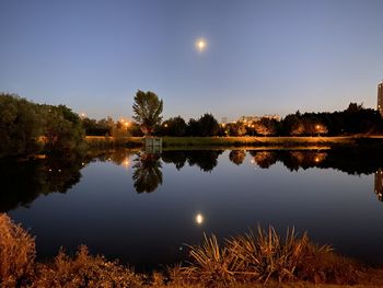 Scenic view of lake against sky at night