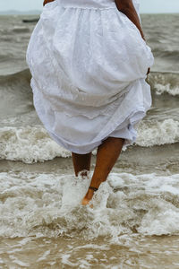 Rear view of woman walking on beach