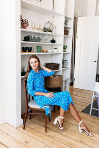 Portrait of woman sitting on chair at home