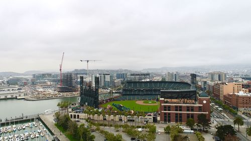 High angle view of buildings against cloudy sky
