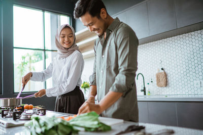 Side view of man preparing food in kitchen