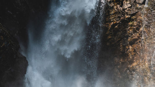 Scenic view of waterfall against sky