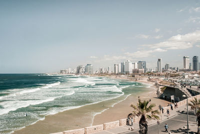 Scenic view of sea and tel aviv cityscape against clear sky