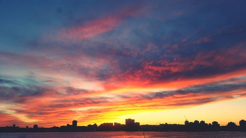 Dramatic sky over city at sunset