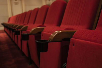 Red empty chairs in movie theater